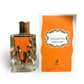 Maison Alhambra Sugar Me Carrot Cake — A clear glass perfume bottle with an orange liquid and gold decorative elements, next to its orange and white striped box with a gold ornate frame containing the product name. | Maison Alhambra Sugar Me Carrot Cake — Botol minyak wangi kaca jernih dengan cecair oren dan elemen