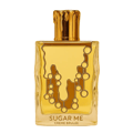 Maison Alhambra Sugar Me Creme Brulee — A clear glass perfume bottle with a gold cap and a yellow and gold decorative front, next to its yellow and white striped box with a decorative gold frame containing the product name. | Maison Alhambra Sugar Me Creme Brulee — Botol minyak wangi kaca jernih dengan penutup emas