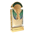 Maison Alhambra La Charmante by Maison Alhambra 100ml EDP — A perfume bottle with a gold and green peacock-inspired cap and ornate detailing on the front, displayed next to its matching dark teal box with art deco-inspired patterns and a deer emblem. | Maison Alhambra La Charmante by Maison Alhambra 100ml EDP — Botol