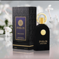 Maison Alhambra Philos Opus Noir by Maison Alhambra 100ml EDP — A black perfume bottle with a gold ring cap and a circular gold emblem on the front, next to its matching black and gold box with the same emblem and text. | Maison Alhambra Philos Opus Noir by Maison Alhambra 100ml EDP — Botol minyak wangi hitam dengan