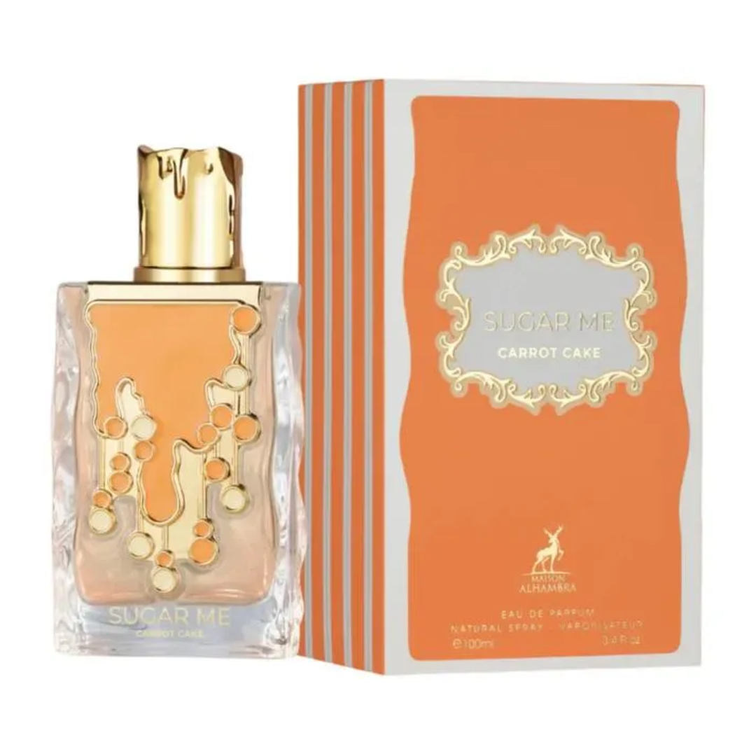 Maison Alhambra Sugar Me Carrot Cake — A clear glass perfume bottle with an orange liquid and gold decorative elements, next to its orange and white striped box with a gold ornate frame containing the product name. | Maison Alhambra Sugar Me Carrot Cake — Botol minyak wangi kaca jernih dengan cecair oren dan elemen
