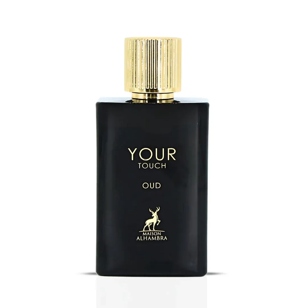 Maison Alhambra Your Touch Oud — A black perfume bottle with a gold cap stands next to its matching black and gold box, both featuring the text 'YOUR TOUCH OUD' and a deer logo. | Maison Alhambra Your Touch Oud — Botol minyak wangi hitam dengan penutup emas berdiri di sebelah kotak hitam dan emasnya, kedua-duanya