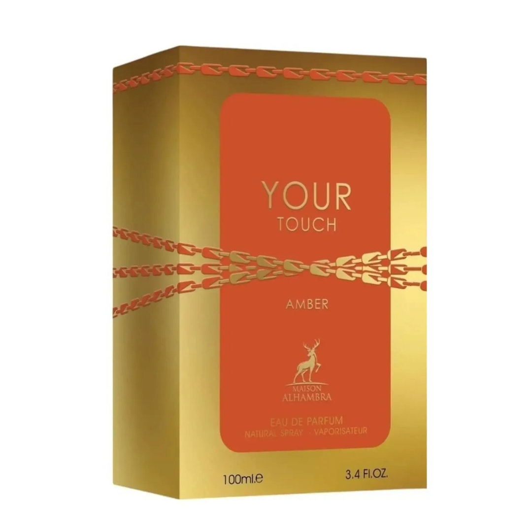 Maison Alhambra Your Touch Amber by Maison Alhambra 100ml — A rectangular amber glass perfume bottle with a gold ribbed cap sits next to its matching gold and orange box, which features a zipper-like design. | Maison Alhambra Your Touch Amber by Maison Alhambra 100ml — Botol kaca amber berbentuk segi empat dengan