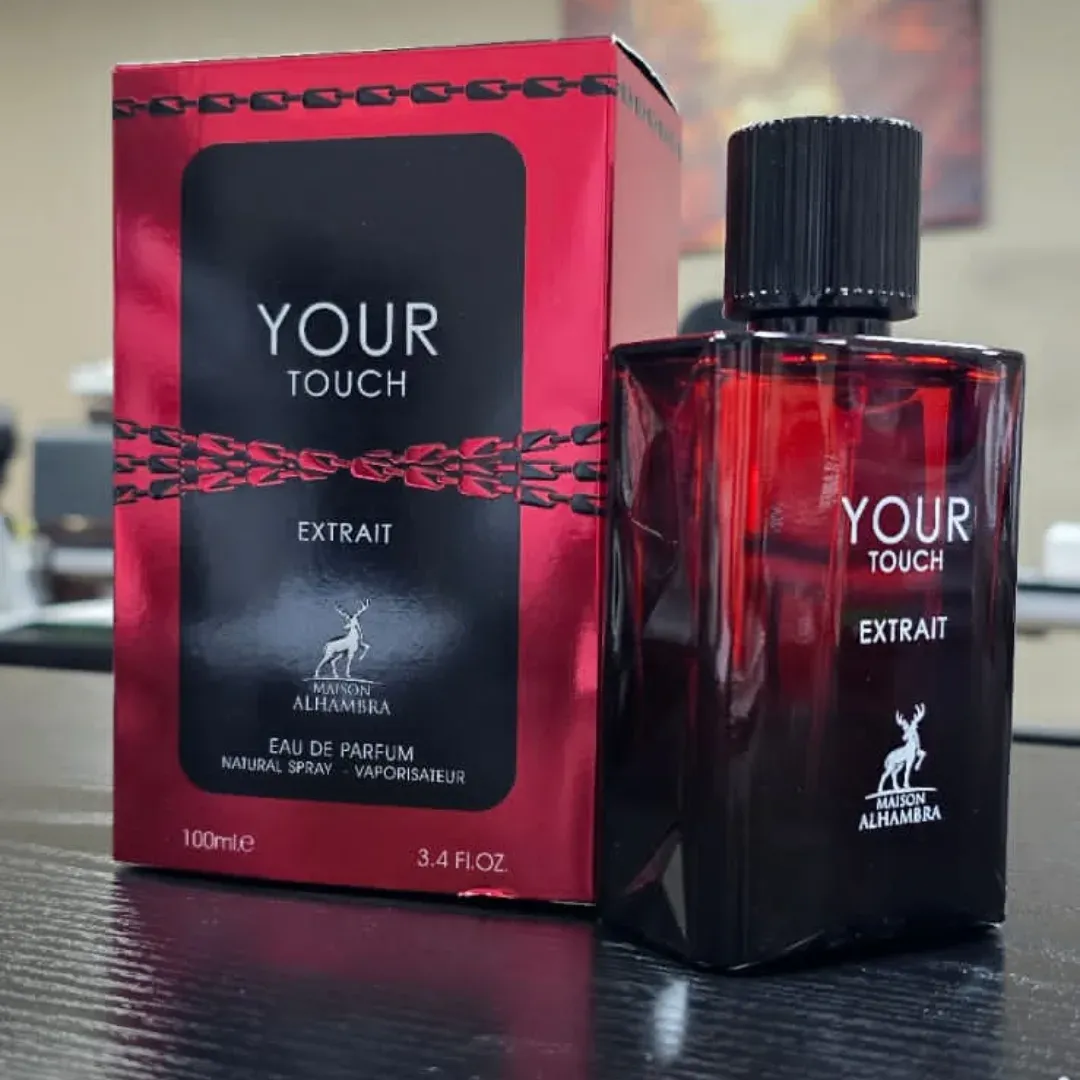 Maison Alhambra Your Touch Extrait — Red and black packaging with a chain design, next to a red glass perfume bottle with a black cap. | Pembungkusan merah dan hitam dengan rekaan rantai, bersebelahan botol minyak wangi kaca merah dengan penutup hitam.