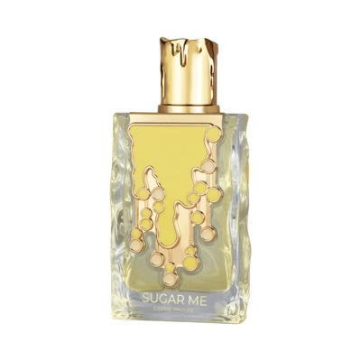 Maison Alhambra Sugar Me Creme Brulee — A clear glass perfume bottle with a gold cap and a yellow and gold decorative front, next to its yellow and white striped box with a decorative gold frame containing the product name. | Maison Alhambra Sugar Me Creme Brulee — Botol minyak wangi kaca jernih dengan penutup emas