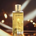 Maison Alhambra Minerale Gold by Maison Alhambra 100ml EDP — A gold-colored perfume bottle and its matching yellow and blue box are displayed side-by-side against a white background. | Maison Alhambra Minerale Gold by Maison Alhambra 100ml EDP — Botol minyak wangi berwarna emas dan kotak padanannya yang berwarna