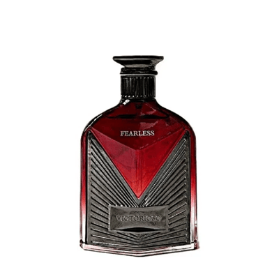 Maison Alhambra Victorioso Fearless by Maison Alhambra 100ml EDP — A red glass perfume bottle with a silver geometric design and a black cap, placed next to its white and red patterned box with the brand logo. | Maison Alhambra Victorioso Fearless by Maison Alhambra 100ml EDP — Botol kaca merah dengan reka bentuk