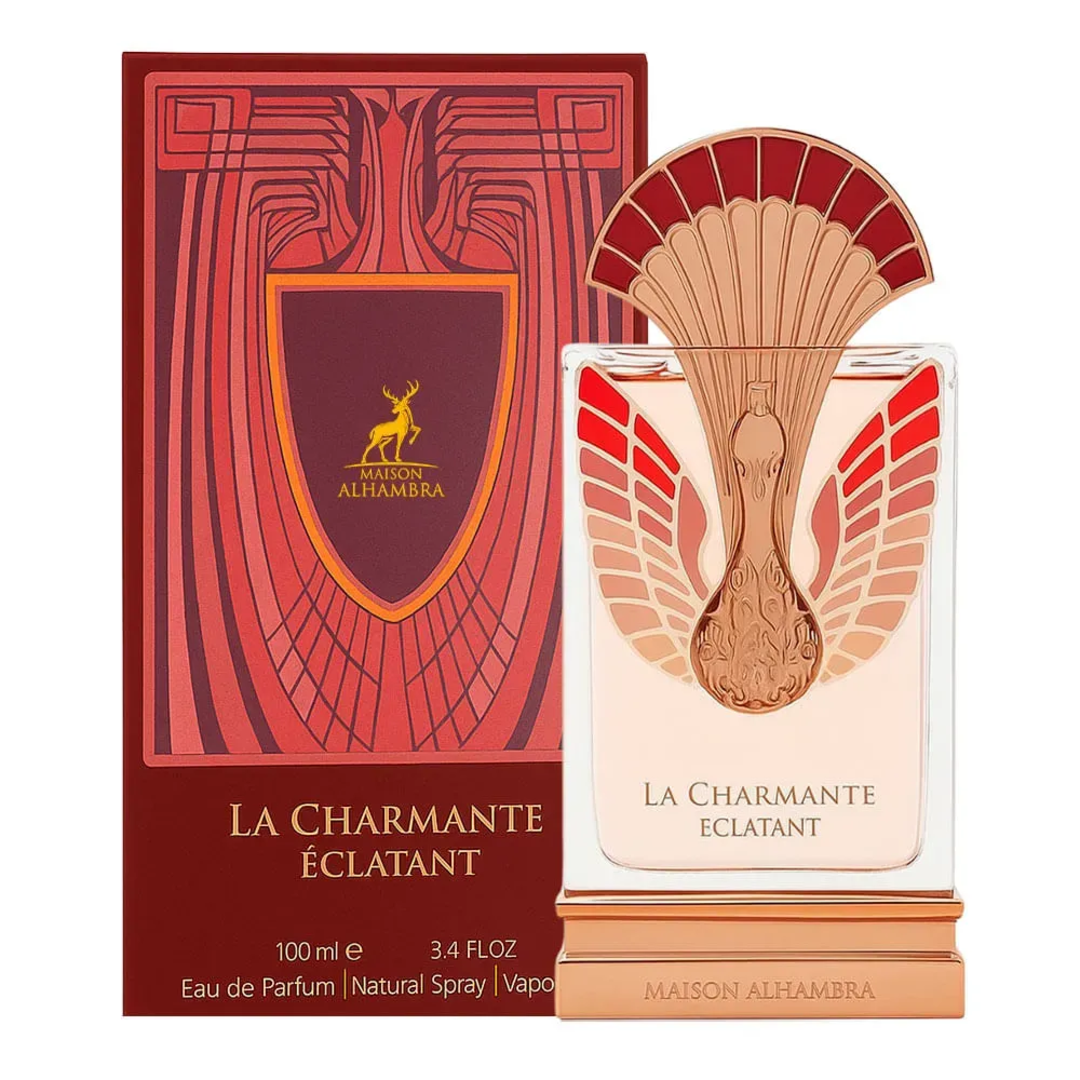 Maison Alhambra La Charmante Eclatant by Maison Alhambra 100ml EDP — A perfume bottle with a decorative fan-like gold and red atomizer sits next to its matching red and gold patterned box. | Maison Alhambra La Charmante Eclatant by Maison Alhambra 100ml EDP — Botol minyak wangi dengan penyembur emas dan merah seperti