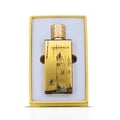Maison Alhambra Minerale Gold by Maison Alhambra 100ml EDP — A gold-colored perfume bottle and its matching yellow and blue box are displayed side-by-side against a white background. | Maison Alhambra Minerale Gold by Maison Alhambra 100ml EDP — Botol minyak wangi berwarna emas dan kotak padanannya yang berwarna