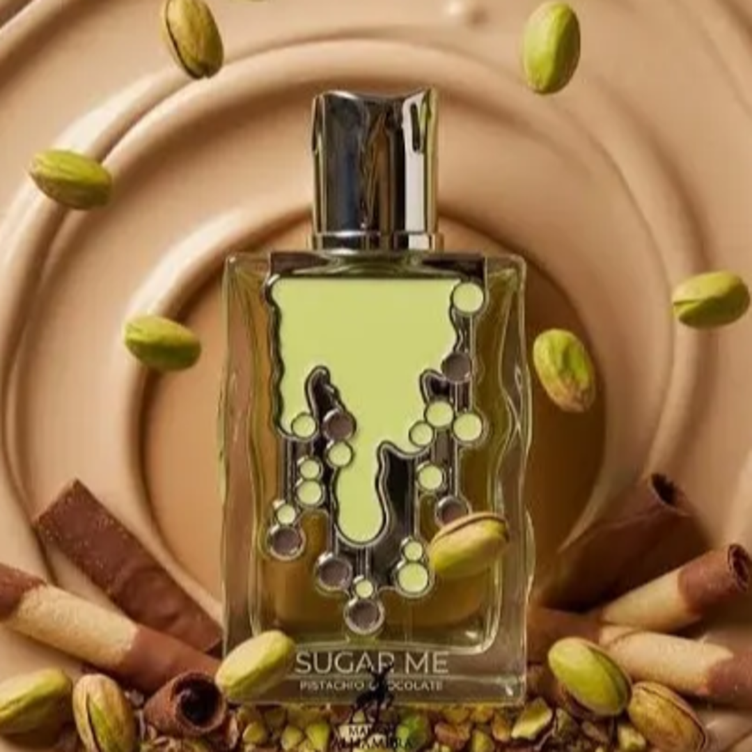 Maison Alhambra Sugar Me Pistachio Chocolate by Maison Alhambra 100ml EDP — A light green perfume bottle with a decorative, dripping design and dark accents, next to its matching light green box with ornate framing and text. | Maison Alhambra Sugar Me Pistachio Chocolate by Maison Alhambra 100ml EDP — Botol minyak