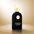 Maison Alhambra Philos Opus Noir by Maison Alhambra 100ml EDP — A black perfume bottle with a gold ring cap and a circular gold emblem on the front, next to its matching black and gold box with the same emblem and text. | Maison Alhambra Philos Opus Noir by Maison Alhambra 100ml EDP — Botol minyak wangi hitam dengan