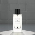 Maison Alhambra L'Impressio Pour Femme — White perfume box and clear glass bottle with black cap, featuring a deer logo and text. | Kotak pewangi putih dan botol kaca jernih bertutup hitam, menampilkan logo rusa dan teks.
