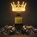 Maison Alhambra B.A.D. Homme — A glowing golden crown hovers above a golden and black perfume bottle, surrounded by shattered glass bottles on a dark background. | Maison Alhambra B.A.D. Homme — Mahkota emas bercahaya melayang di atas botol minyak wangi emas dan hitam, dikelilingi oleh botol kaca yang pecah di latar