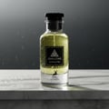 Maison Alhambra Jean Lowe Immortel — A clear glass perfume bottle with yellow liquid, covered in water droplets, sits on a marble surface with water splashes. The background is a dark, moody gradient with falling water. | Maison Alhambra Jean Lowe Immortel — Botol kaca jernih berisi cecair kuning, dilitupi titisan