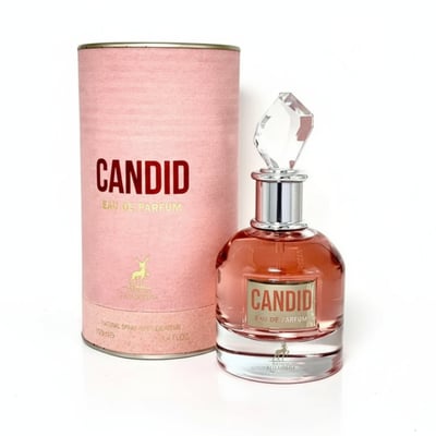 Maison Alhambra Candid Eau de Parfum for Women — Pink textured cylindrical box and a clear glass perfume bottle with pink liquid and a faceted crystal cap, set against a white background. | Maison Alhambra Candid Eau de Parfum untuk Wanita — Kotak silinder bertekstur merah jambu dan botol minyak wangi kaca jernih