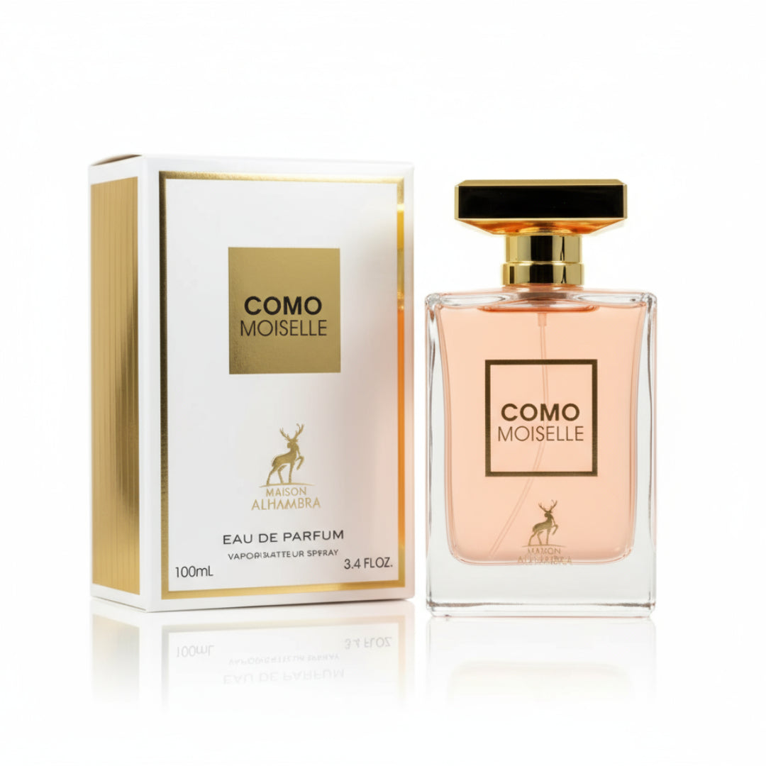 Maison Alhambra Como Moiselle by Maison Alhambra 100ml for Her — A white and gold perfume box stands next to a clear glass bottle of pink perfume with a gold cap. | Maison Alhambra Como Moiselle by Maison Alhambra 100ml for Her — Kotak minyak wangi putih dan emas berdiri di sebelah botol kaca jernih berisi minyak
