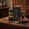 Maison Alhambra Dark Aoud by Maison Alhambra 80ml EDP — A dark oud perfume bottle and box are displayed on a wooden table with a comb, watch, shaving brush, and a small bowl of oud chips and a flower. | Maison Alhambra Dark Aoud by Maison Alhambra 80ml EDP — Botol dan kotak minyak wangi oud gelap dipamerkan di atas