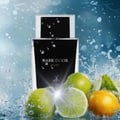 Maison Alhambra Dark Door Sport Men 100ml EDP — A perfume bottle with the label "DARK DOOR SPORT" is surrounded by splashing water and fresh limes and a lemon. | Maison Alhambra Dark Door Sport Men 100ml EDP — Botol minyak wangi berlabel "DARK DOOR SPORT" dikelilingi oleh percikan air serta limau dan lemon segar.