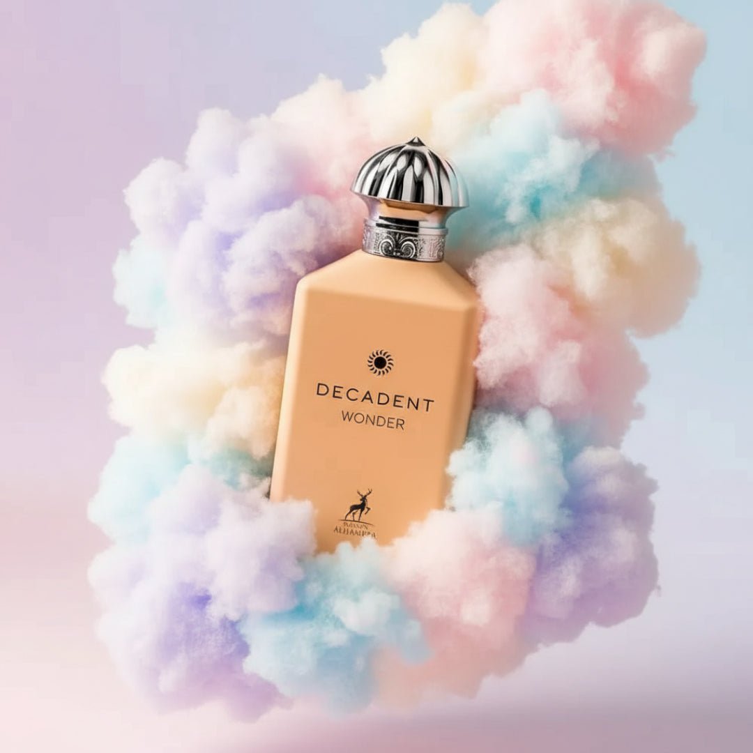 Maison Alhambra Decadent Wonder Her EDP 100 ml Alhambra — A peach-colored perfume bottle is surrounded by fluffy, pastel-colored clouds against a gradient background. | Maison Alhambra Decadent Wonder Her EDP 100 ml Alhambra — Botol minyak wangi berwarna pic dikelilingi oleh awan gebu berwarna pastel dengan latar
