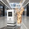Maison Alhambra Ebene by Maison Alhambra Perfume 90 ml EDP — A white box and a glass perfume bottle with golden cracks and flames erupting from the top, set against a blurred shopping mall background. Scent notes of Vanilla, Amber, Benzoin, and Musk are listed. | Maison Alhambra Ebene by Maison Alhambra Perfume 90 ml