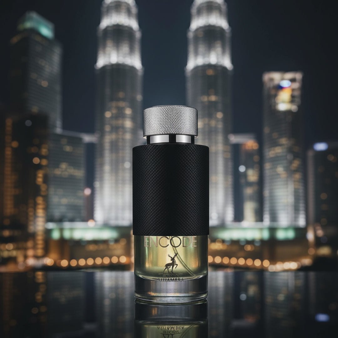 Maison Alhambra Encode By Maison Alhambra 100ml for Man — A glass perfume bottle with a black textured band and a silver cap, set against a blurred nighttime cityscape with illuminated skyscrapers. | Maison Alhambra Encode By Maison Alhambra 100ml for Man — Botol minyak wangi kaca dengan jalur bertekstur hitam dan