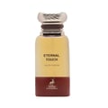 Maison Alhambra Eternal Touch — A clear glass perfume bottle with a gold ridged cap and a maroon base featuring a deer silhouette and brand name. | Maison Alhambra Eternal Touch — Botol minyak wangi kaca jernih dengan penutup berjalur emas dan tapak merah marun menampilkan siluet rusa dan nama jenama.