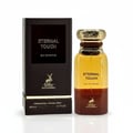 Maison Alhambra Eternal Touch by Maison Alhambra 80ml EDP — A dark brown textured box stands next to a clear glass perfume bottle with a gold ridged cap and a gradient of yellow to brown liquid. | Maison Alhambra Eternal Touch by Maison Alhambra 80ml EDP — Kotak bertekstur coklat gelap berdiri di sebelah botol minyak