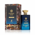 Maison Alhambra Ethnic Oud — A rectangular blue glass perfume bottle with a gold cap stands next to its matching patterned box, both featuring the Ethnic Oud logo and a deer silhouette. | Maison Alhambra Ethnic Oud — Botol kaca biru berbentuk segi empat dengan penutup emas berdiri di sebelah kotak bermotif yang