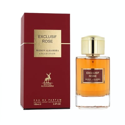 Maison Alhambra Exclusif Rose — A red box and a glass perfume bottle with golden cap and amber liquid, both featuring gold text and a deer logo. | Maison Alhambra Exclusif Rose — Kotak merah dan botol minyak wangi kaca dengan penutup emas dan cecair ambar, kedua-duanya menampilkan teks emas dan logo rusa.