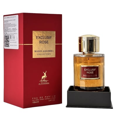 Maison Alhambra Exclusif Rose — A red box and a glass perfume bottle with gold accents, both featuring the 'Exclusif Rose' label. The bottle contains amber-colored liquid and sits on a black stand. | Maison Alhambra Exclusif Rose — Peti merah dan botol minyak wangi kaca dengan aksen emas, kedua-duanya mempunyai label