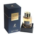 Maison Alhambra Exclusif Saffron – A navy blue box with gold accents stands next to a clear glass perfume bottle with a gold cap, both featuring gold labels. | Maison Alhambra Exclusif Saffron – Kotak biru laut dengan aksen emas berdiri di sebelah botol minyak wangi kaca jernih dengan penutup emas, kedua-duanya