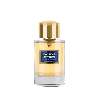 Maison Alhambra Exclusif Saffron — A clear glass perfume bottle with a golden cap and a blue label reading "EXCLUSIF SAFFRON" and "MAISON ALHAMBRA COLLECTION". | Maison Alhambra Exclusif Saffron — Botol minyak wangi kaca jernih dengan penutup keemasan dan label biru bertuliskan "EXCLUSIF SAFFRON" dan "MAISON ALHAMBRA