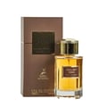 Maison Alhambra Exclusif Tabac — Brown box and amber glass perfume bottle with gold cap, featuring deer logo and text details. | Maison Alhambra Exclusif Tabac — Kotak coklat dan botol minyak wangi kaca berwarna ambar dengan penutup emas, menampilkan logo rusa dan butiran teks.