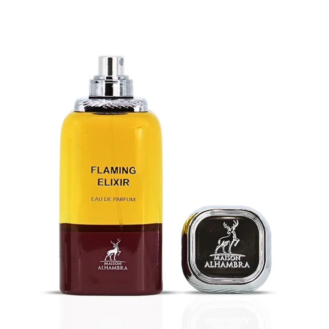 Maison Alhambra Flaming Elixir — A bottle of amber and burgundy Eau de Parfum stands next to its matching burgundy box with a white label. | Maison Alhambra Flaming Elixir — Sebotol Eau de Parfum berwarna kuning dan burgundy berdiri di sebelah kotak burgundy yang sepadan dengan label putih.