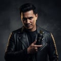 Maison Alhambra Glacier Le Noir by Maison Alhambra 100ml Men — Man in leather jacket holding a black perfume bottle with gold accents, smoke effect in background | Maison Alhambra Glacier Le Noir by Maison Alhambra 100ml Men — Lelaki berbaju kulit memegang botol minyak wangi hitam dengan aksen emas, kesan asap di