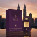 Maison Alhambra Infini Intoxicating Cherry — A purple perfume box and bottle stand on a reflective surface with a city skyline and twin towers in the background at sunset. | Maison Alhambra Infini Intoxicating Cherry — Kotak dan botol minyak wangi ungu berdiri di permukaan reflektif dengan latar belakang langit bandar