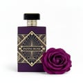 Maison Alhambra Infini Rose by Maison Alhambra 100ml EDP Unisex — A purple perfume bottle with a gold art deco design and the text 'INFINI ROSE' and 'MAISON ALHAMBRA' is placed next to a deep purple rose on a white background. | Botol minyak wangi ungu dengan reka bentuk art deco emas dan teks 'INFINI ROSE' dan