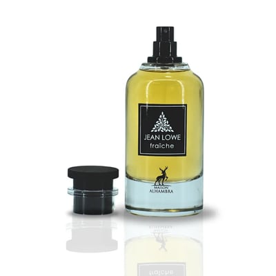 Maison Alhambra Jean Lowe Fraiche — A clear glass perfume bottle with yellow liquid, a black cap is placed next to it on a reflective surface. | Maison Alhambra Jean Lowe Fraiche — Botol minyak wangi kaca jernih dengan cecair kuning, penutup hitam diletakkan di sebelahnya di atas permukaan reflektif.