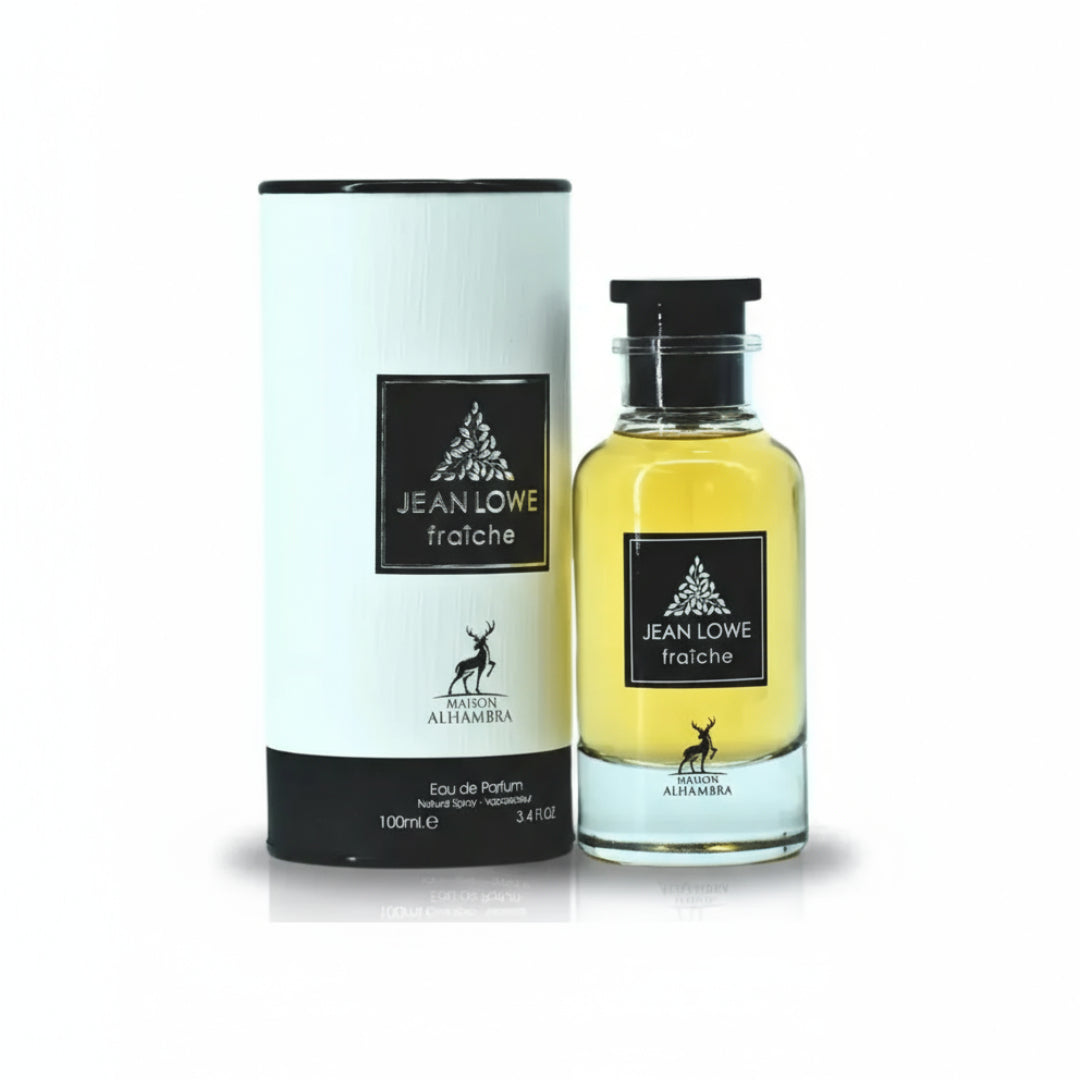 Maison Alhambra Jean Lowe Fraiche — A clear glass bottle of yellow perfume with a black cap stands next to its white cylindrical box, both featuring a black label with a deer silhouette and text. | Maison Alhambra Jean Lowe Fraiche — Sebotol minyak wangi kaca jernih berisi minyak wangi kuning dengan penutup hitam