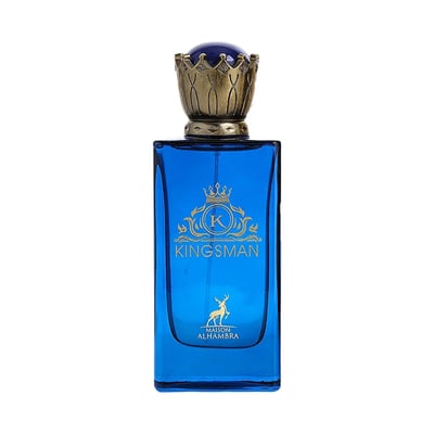 Maison Alhambra Kingsman – Blue glass perfume bottle with gold crown cap and gold emblem, next to a navy blue and gold striped box with matching emblem and deer graphic. | Maison Alhambra Kingsman – Botol minyak wangi kaca biru dengan penutup mahkota emas dan lambang emas, bersebelahan kotak berjalur biru navy dan