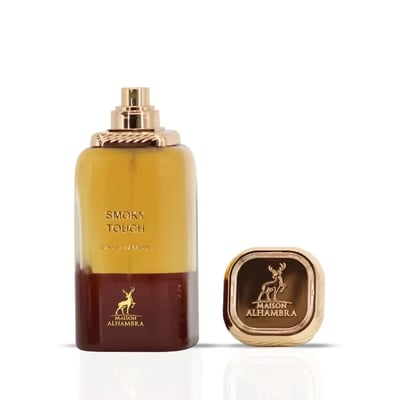 Maison Alhambra Smoky Touch by Maison Alhambra 80ml EDP — A clear glass perfume bottle with a gradient of yellow to brown liquid, a gold cap, and a gold emblem of a deer on the bottle and cap, shown next to the detached gold cap. | Maison Alhambra Smoky Touch by Maison Alhambra 80ml EDP — Botol minyak wangi kaca