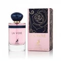 Maison Alhambra La Voie by Maison Alhambra 100ml for Her — A pink glass perfume bottle with a dark blue marbled cap sits next to its matching pink box featuring a black and gold rose design. | Maison Alhambra La Voie by Maison Alhambra 100ml for Her — Botol kaca merah jambu dengan penutup biru gelap berjalak duduk di
