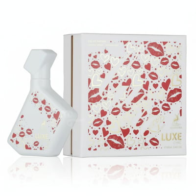 Maison Alhambra Luxe Chic – White perfume bottle with red lips and hearts pattern next to a matching white box with the same design. | Maison Alhambra Luxe Chic – Botol minyak wangi putih dengan corak bibir merah dan hati di sebelah kotak putih dengan reka bentuk yang sama.