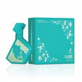 Maison Alhambra Luxe Emerald Perfume Maison Alhambra 100ml Unisex — A teal perfume bottle with a gold geometric pattern sits next to its matching teal box, also with gold geometric accents. | Maison Alhambra Luxe Emerald Perfume Maison Alhambra 100ml Unisex — Botol minyak wangi teal dengan corak geometri emas terletak