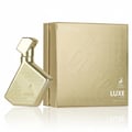 Maison Alhambra Luxe Gold – A gold-colored perfume bottle with a geometric design and a matching gold box with embossed circular patterns and the brand logo. | Maison Alhambra Luxe Gold – Botol pewangi berwarna emas dengan reka bentuk geometri dan kotak emas yang sepadan dengan corak bulatan timbul dan logo jenama.