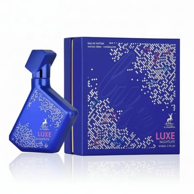 Maison Alhambra Luxe Nightlife — A blue perfume bottle with a white dotted pattern and the brand logo, placed next to its matching blue box with a similar dotted pattern and the word 'Luxe' in script. | Maison Alhambra Luxe Nightlife — Botol minyak wangi biru dengan corak titik putih dan logo jenama, diletakkan di