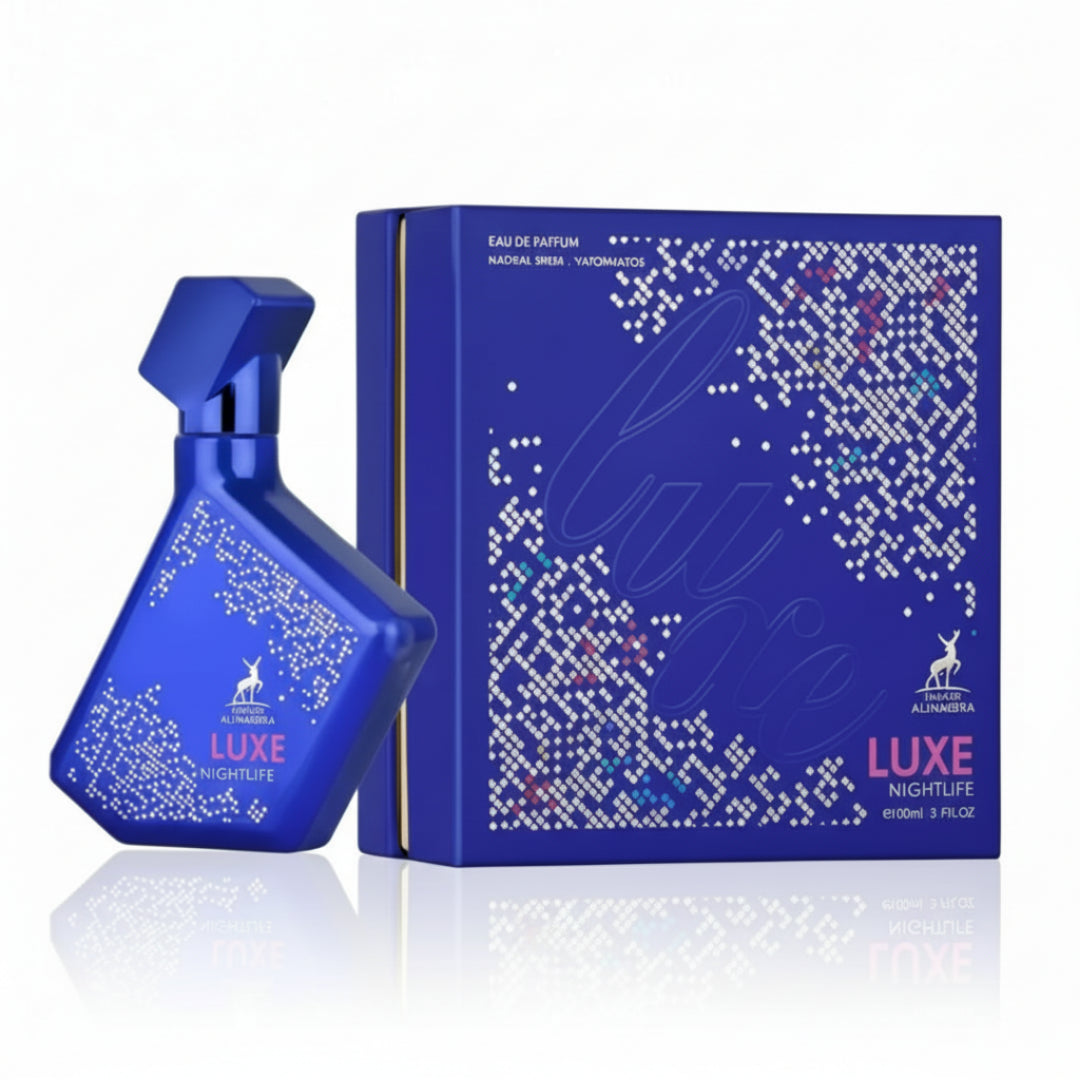 Maison Alhambra Luxe Nightlife — A blue perfume bottle with a white dotted pattern and the brand logo, placed next to its matching blue box with a similar dotted pattern and the word 'Luxe' in script. | Maison Alhambra Luxe Nightlife — Botol minyak wangi biru dengan corak titik putih dan logo jenama, diletakkan di
