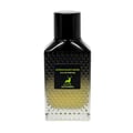 Maison Alhambra Extravagant Lover – A clear glass perfume bottle with a black faceted cap and a black label featuring a green deer silhouette and text. The liquid inside is pale yellow. | Maison Alhambra Extravagant Lover – Botol minyak wangi kaca jernih dengan penutup hitam berfaset dan label hitam menampilkan siluet