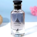Maison Alhambra Jean Lowe Matiere — Clear glass perfume bottle with a black cap and silver accents, featuring a black leaf logo and text "JEAN LOWE matière" and a deer silhouette with "MAISON ALHAMBRA" text below. | Botol minyak wangi kaca jernih dengan penutup hitam dan perak, menampilkan logo daun hitam dan teks