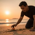 Maison Alhambra Terra by Maison Alhambra – 50 ml Unisex — Man kneeling on a sandy beach at sunset, reaching for a perfume bottle partially buried in the sand. The sun is setting over the ocean in the background. | Maison Alhambra Terra by Maison Alhambra – 50 ml Unisex — Lelaki berlutut di pantai berpasir semasa